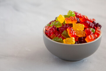 Colorful Fruity Gummy Bears in a Bowl, side view. Copy space.