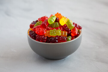 Colorful Fruity Gummy Bears in a Bowl, side view.