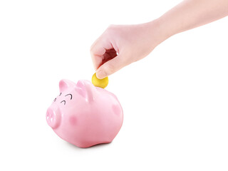 Hand puts gold coins into a piggy bank PNG transparent