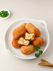 Croquettes, consisting of chicken and ragout coated with egg and panir flour and then fried. 
