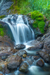Fototapeta na wymiar The photo of the Air Terjun Sikarim waterfall in Dieng, Indonesia.