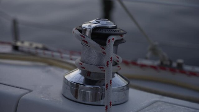 This stock video footage features a close-up detail shot of a winch on a sailboat.