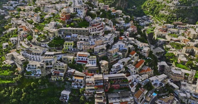Positano Italy Aerial v3 birds eye view, flyover coastal cliffside town capturing charming neighborhood, narrow streets and terraced buildings with colorful facade - Shot with Mavic 3 Cine - May 2023