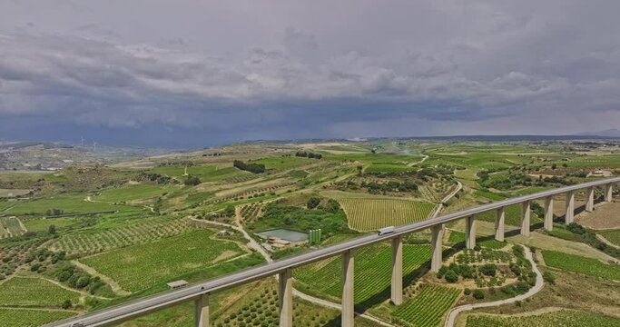 Borgo Vecchio Italy Aerial v2 drone flyover and around old village town along highway bridge capturing a vast landscape of agricultural farmlands and vineyards - Shot with Mavic 3 Cine - June 2023