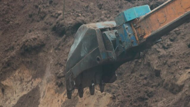auto excavator with rotary bucket and telescopic boom digs a hole to replace the pipeline, industry