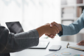 Close-up of businesswoman handshake with partner to celebration partnership and business deal concept.