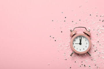 Pink watch on a festive background with sparkles.