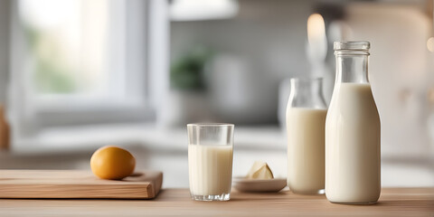 Wooden tabletop counter with Bottle and glass of tasty milk. in front of bright out of focus kitchen. copy space