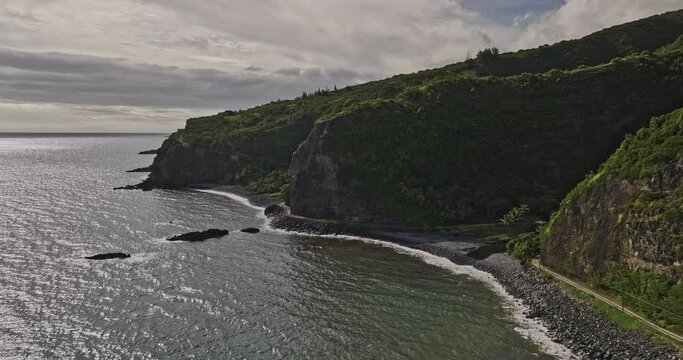 Maui Hawaii Aerial v50 cinematic drone fly along rocky coastline capturing Hana highway passing through mountainous terrain, Alelele bridge and Kalepa gulch - Shot with Mavic 3 Cine - December 2022