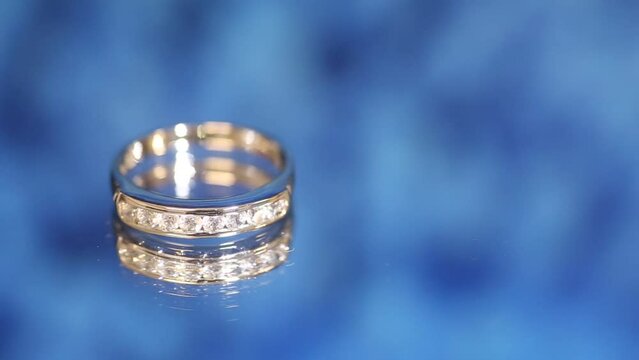 White gold ring set with diamonds photographed on blue