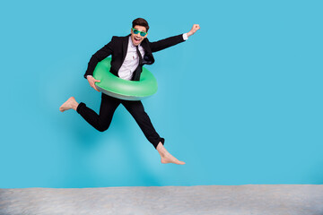 Full length photo of positive funny guy dressed black tuxedo jumping finally flying vacation empty...
