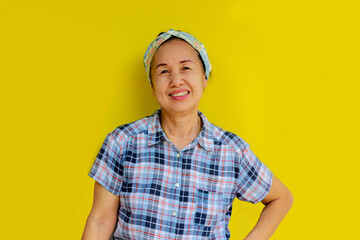Standing woman smiling happily isolated on yellow background