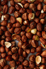 Fresh, young, unroasted hazelnuts or hazelnut kernels. Against the background of a delicate white curtain. Daylight. Natural color.