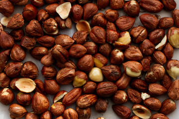 Fresh, young, unroasted hazelnuts or hazelnut kernels. Against the background of a delicate white curtain. Daylight. Natural color.