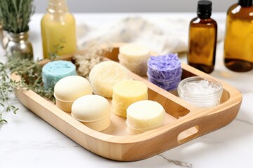 Obraz na płótnie Canvas homemade shampoo bars on a wooden tray with other hair care products