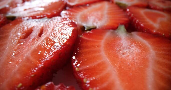 Bright red slices of fresh juicy strawberries closeup. Strawberry background