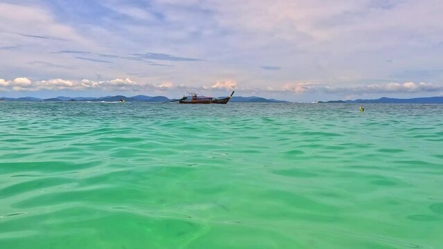 Phi Phi island off the coast of phuket thailand. Phi phi island is famous for turquoise clear blue waters teaming with Corel reef fish white soft sand and lush green trees.
