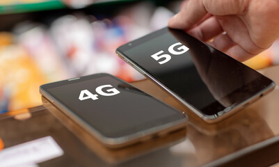 Hand picks mobile phone with the expression '5G' instead of '4G'.