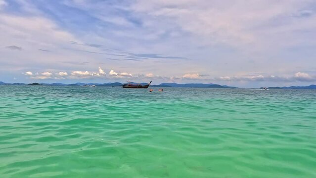 Phi Phi island off the coast of phuket thailand. Phi phi island is famous for turquoise clear blue waters teaming with Corel reef fish white soft sand and lush green trees.