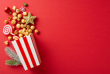 Deck the halls for New Year's film night: striped cardboard bucket with delicious popcorn, baubles,...