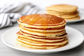 stacks of plain pancakes on a plain white plate