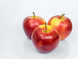 Three red ripe Gala apples isolated on a white background