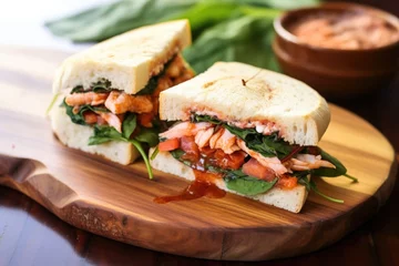 Wandaufkleber red bush tea marinated shrimp sandwich on a wooden dish © altitudevisual