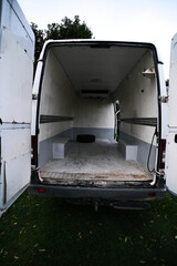 Empty old dirty refrigerated truck inside, with cargo area lighting. Interior of van for...