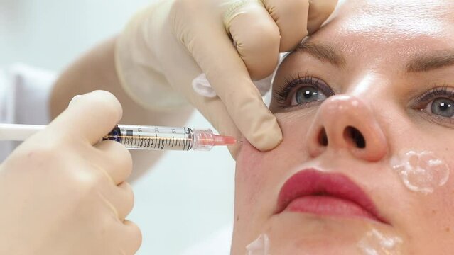 Russia, Perm 10.9.2023. Cosmetologist Give the injection with an IBSA syringe. Cosmetic rejuvenation procedure. Aging beautifully. Facial care using cometology. Fighting wrinkles and sagging skin