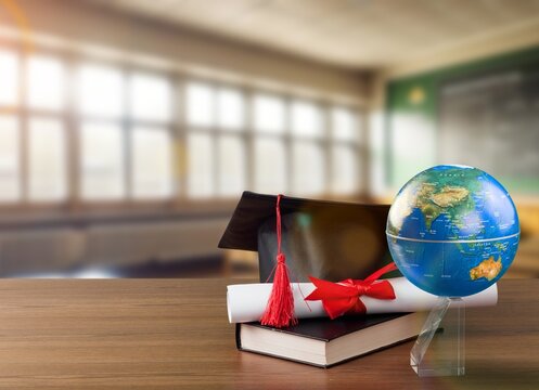 Graduation cap with on wooden desk in classroom, AI generated image