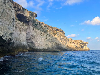 Fototapeta na wymiar Sea grottoes and caves of Sicily. Sea Caves Tour Ortigia in Siracusa. Sea grottoes of Syracuse. Boat trip in Sicily, coastal cliffs