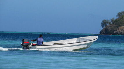 Fototapeta na wymiar A person riding a boat in Fiji