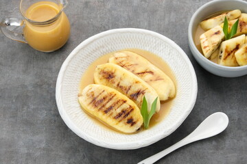 Pisang Gapit or Pisang Epe, grilled banana with palm sugar sauce. Indonesian traditional food.
