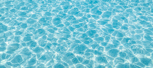 Surface of blue swimming pool, background of water in swimming pool. Blue ripped water in swimming...
