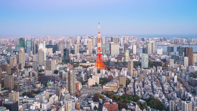 4k Time lapse Day to night of Tokyo tower with buildings in Tokyo City, Japan. Video Zoom In.