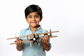Indian little boy showing toy airplane on white background