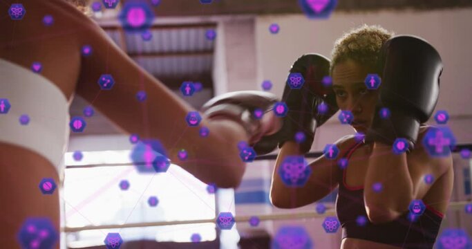 Animation of icons over diverse female boxers practicing punches and to block punches