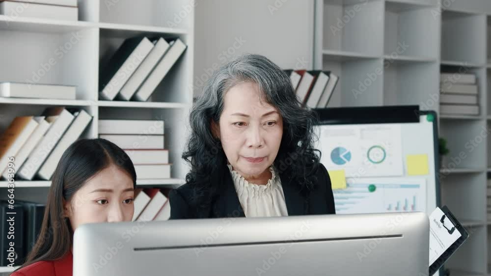 Wall mural Senior businesswoman has work meeting with employees in the finance department, senior female leaders in organization, company financial planning meeting. Concept of meeting together in the company.