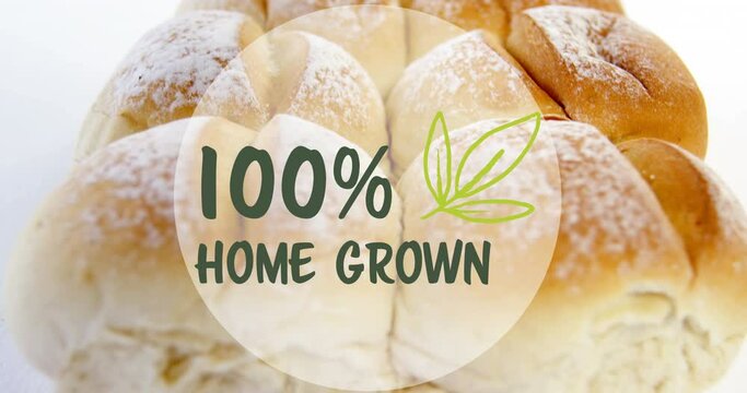 Animation of 100 percent home grown text banner against close up of fresh bread on white background