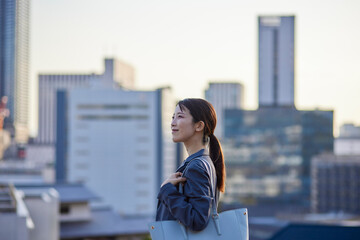 ビジネス街にて遠くを見つめる日本人ビジネスウーマン