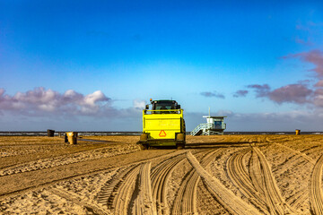 Photograph of a tractor arranging and tilling the sand on the beach in the city of Santa Monica in...