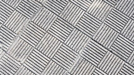 Pavement of cement slabs decorated with lines and squares