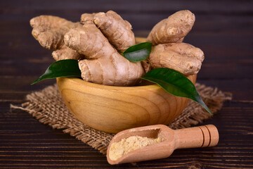 Fresh ginger root in a wooden bowl on a wooden table.Close-up.
