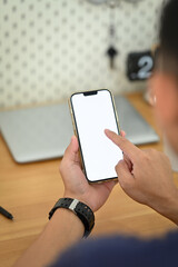 View over shoulder man hand texting or messaging online on smartphone