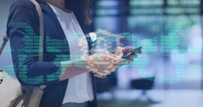 Animation of security padlock and chain icon over biracial businesswoman using smartphone at office