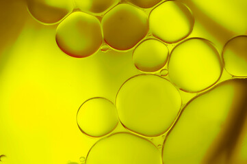 Closeup of bubbles of olive oil. Gold green