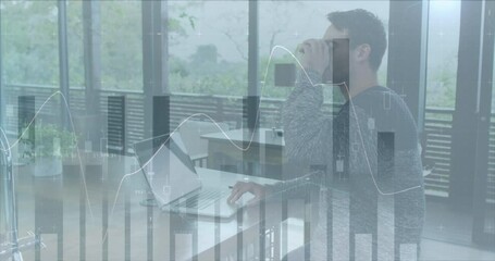 Animation of multiple graphs over caucasian man drinking coffee while working on laptop - Powered by Adobe
