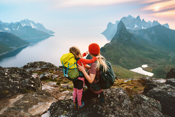 Mother hiking with kid daughter family travel hobby active vacations outdoor in Norway healthy...