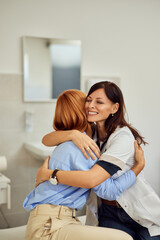 A doctor hugging her patient, looking happy, taking care of the patient.