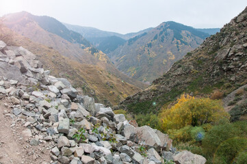 Picturesque autumn mountains in Almaty region with boulders in the foreground, the Republic of Kazakhstan